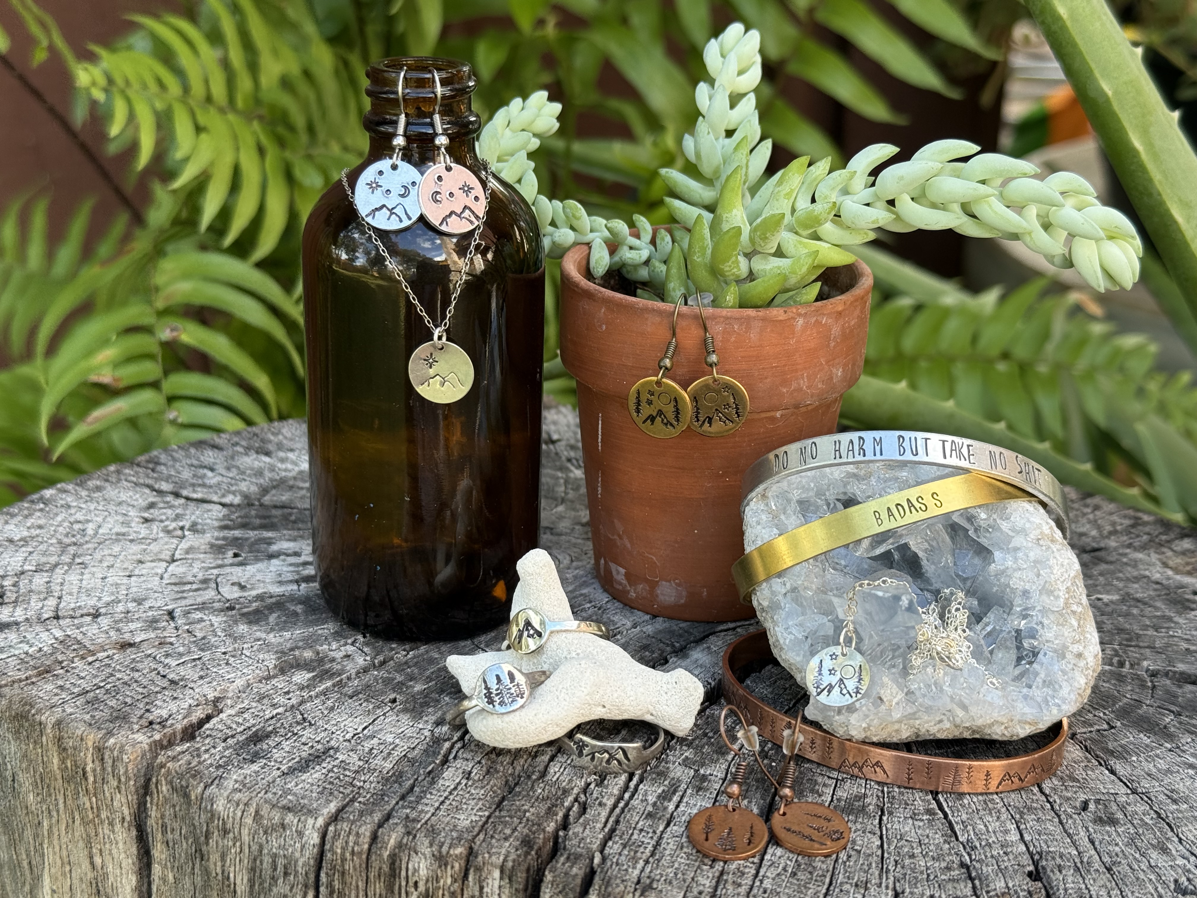 Handmade jewelry laid out on a studio workbench